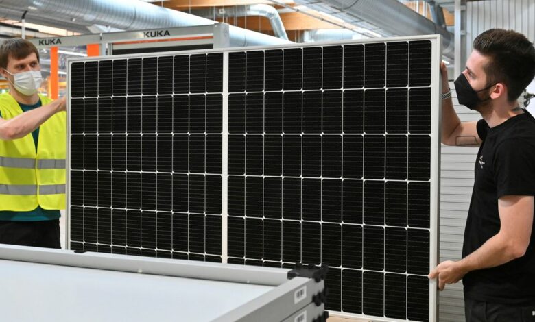 Technicians sort solar panels on the final production line at photovoltaics systems maker Solarwatt in Dresden