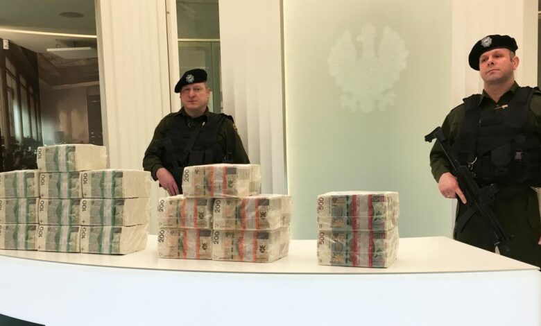 Security men at the Polish central bank headquarters guard piles of cash worth 1 million zlotys