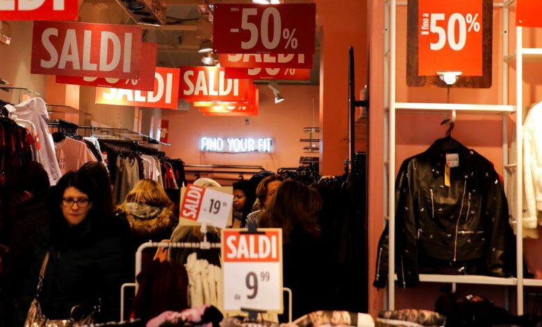 Signs advertising the winter sales are displayed in a retail shop, in Rome