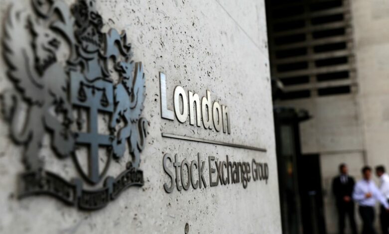 Pedestrians leave and enter the London Stock Exchange in London