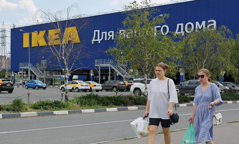 People walk near a closed IKEA store in Kotelniki