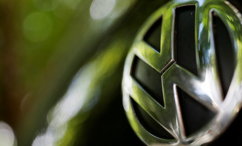 A logo of German carmaker Volkswagen is seen on a car parked on a street in Paris