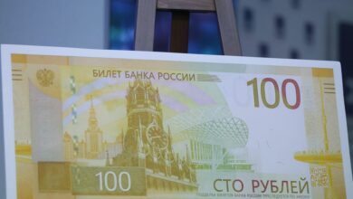 A mock-up of the newly designed Russian 100-rouble banknote is on display during a presentation in Moscow