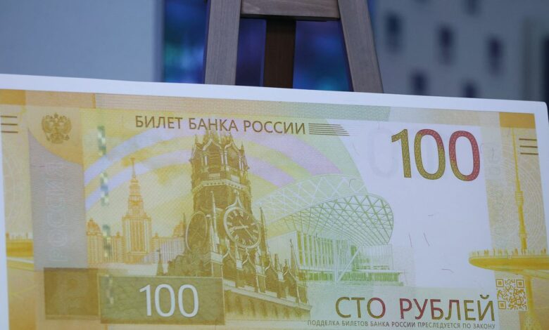A mock-up of the newly designed Russian 100-rouble banknote is on display during a presentation in Moscow