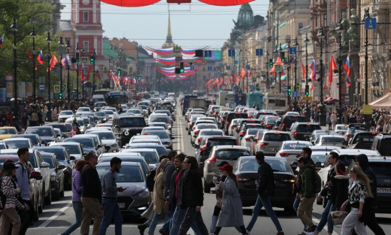 Pedestrians walk across Nevsky Avenue in central Saint Petersburg