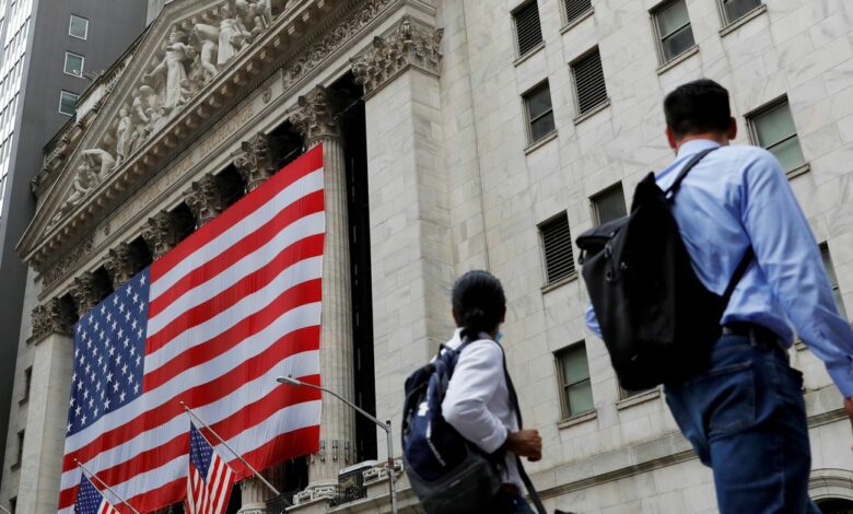 People walk by the New York Stock Exchange (NYSE) in Manhattan, New York City