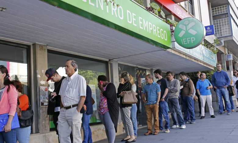 People wait at the employment center to open in Sintra