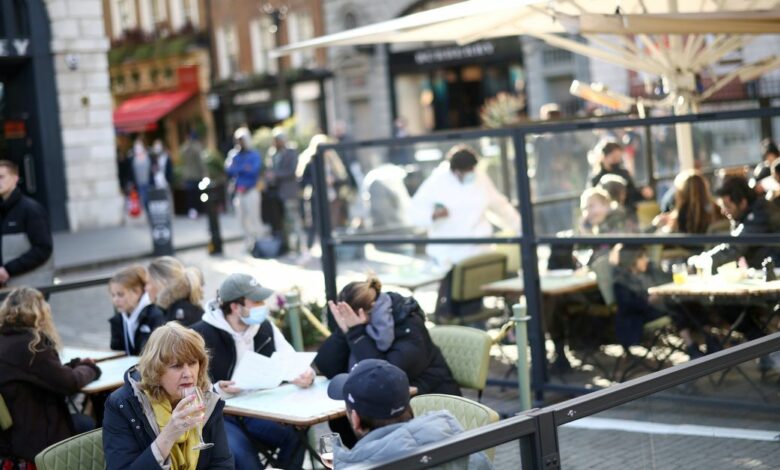 People sit at an outside restaurant area, as the coronavirus disease (COVID-19) restrictions ease, at Covent Garden in London,