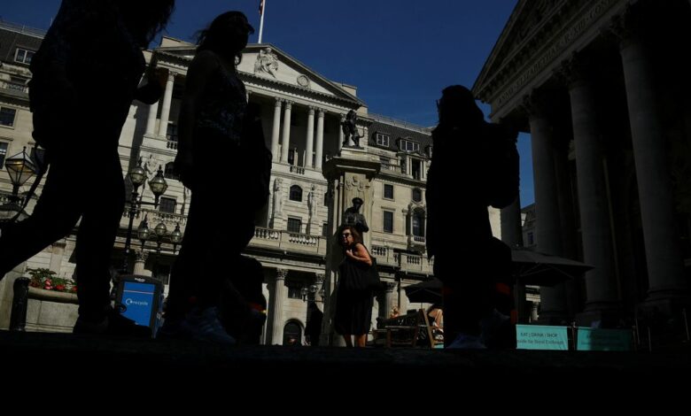 Pedestrians walk past the Bank of England, in London