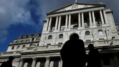 City workers walk past the Bank of England in the City of London, Britain
