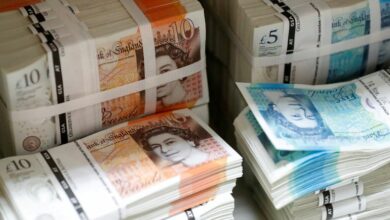 Wads of British Pound Sterling banknotes are stacked in piles at the Money Service Austria company