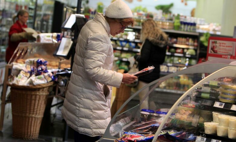 A woman looks at refrigerated products in a Spar store in Budapest