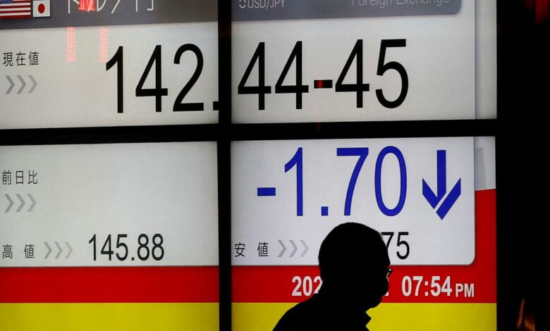A man is silhouetted in front of a board displaying the Japanese yen exchange rate against the U.S. dollar outside a brokerage, after Japan intervened in the currency market for the first time since 1998 to shore up the battered yen, in Tokyo