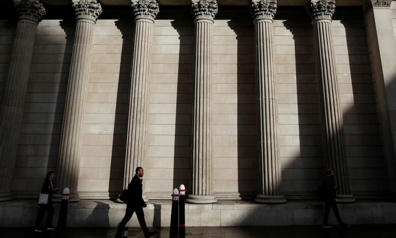 A commuter walks past the Bank of England, in London