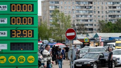 Drivers stay in line outside a petrol station as they try to buy fuel in Kyiv