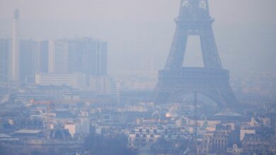 The Eiffel Tower is surrounded by a small-particle haze which hangs above the skyline in Paris