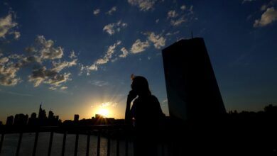 The sun sets behind the skyline of Frankfurt