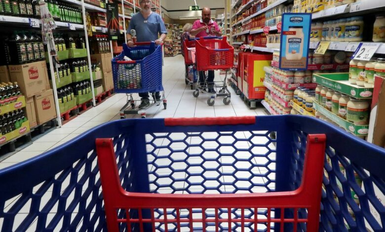 People push a shopping cart in a Carrefour supermarket in Cabrera de Mar