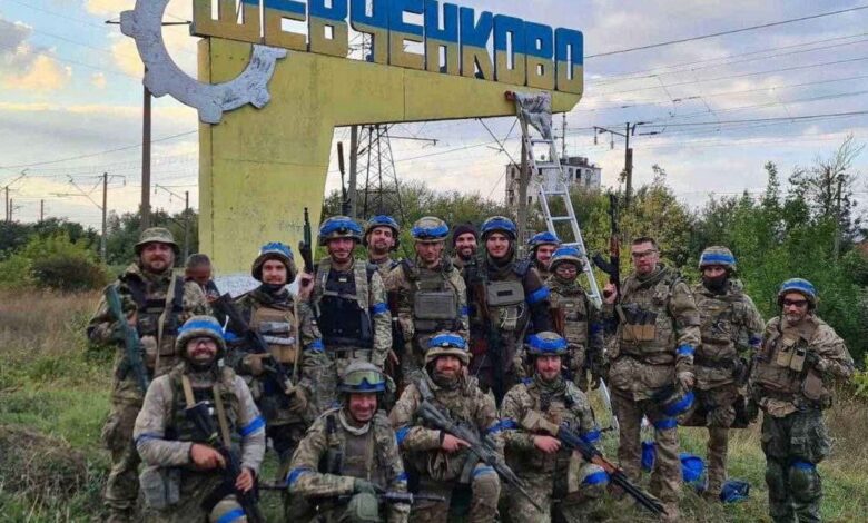 Ukrainian service members pose for in the recently liberated settlement of Vasylenkove in Kharkiv region