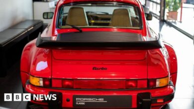 A Porsche 911 Turbo at a Porsche dealership.