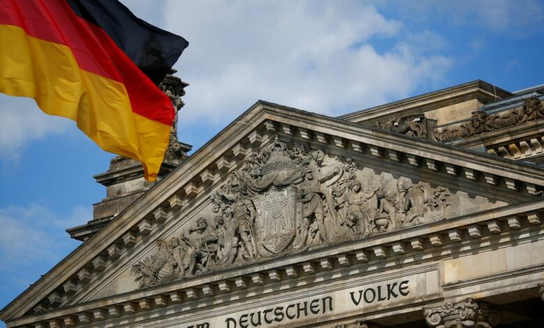 A German flag flutters in front of the Reichstag building in Berlin, Germany