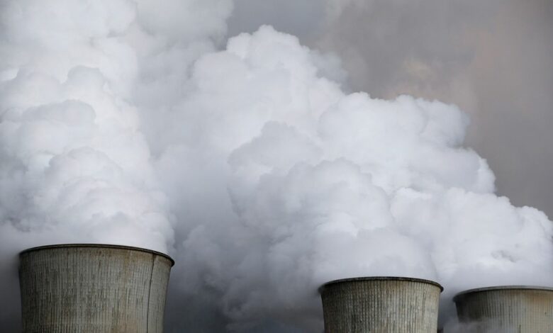 Steam rises from the cooling towers of the coal power plant of RWE in Niederaussem