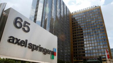 The logo of German publisher Axel Springer is pictured in front of the company