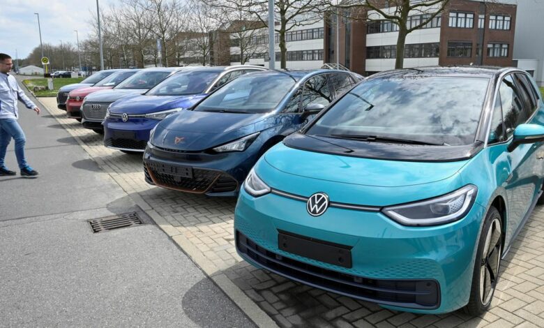 Electric car models of the Volkswagen Group are parked outside the company